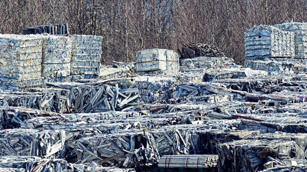 recycled metal bales stacked outside ready to be reused