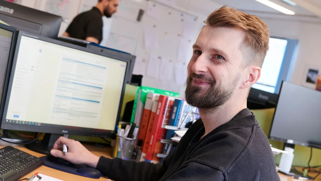 Piotr Sosienko (Axil employee) sitting at desk at Cannock site