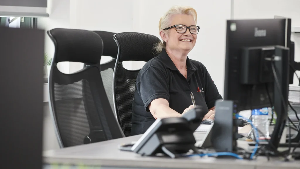 Axil employee working at desk smiling