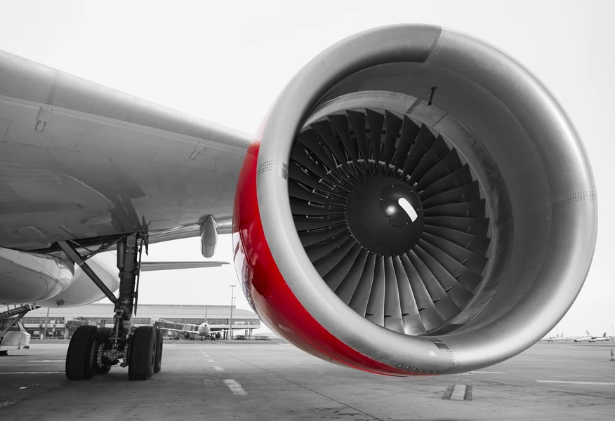 Close-up of a commercial aircraft jet engine on the airport apron highlighting aviation engineering and aerospace operations.
